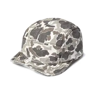 Detail of five-panel camo cap showing side metal eyelets and durable canvas fabric