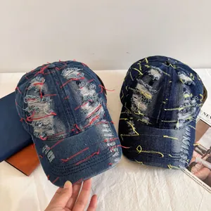 Vintage washed denim baseball cap with heavy distressed details and contrast stitching