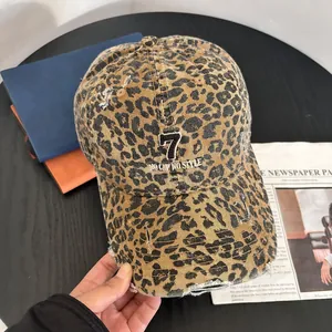 Close-up of leopard print baseball cap featuring embroidery and distressed details