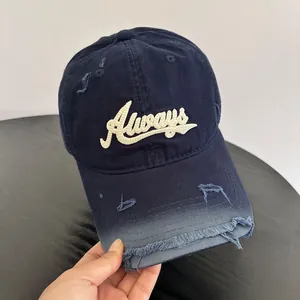 Close-up of distressed navy blue baseball cap with white 3D embroidered Always text