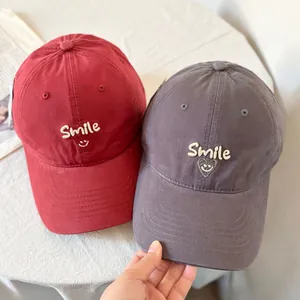 Fashionable baseball caps with Smile embroidery in burgundy and dark grey cotton fabric