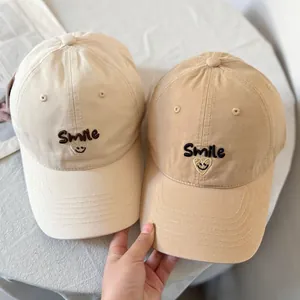 Beige and khaki cotton baseball caps with Smile face embroidery and wide brims