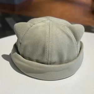 Detailed view of sage green dock worker cap with 3D cat ear design and rolled brim style