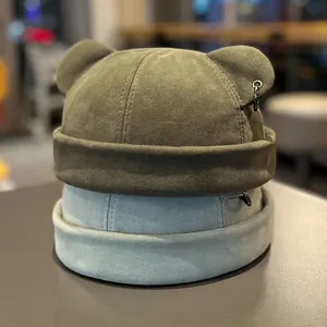 Japanese street style skull cap with cute cat ears and metal ring detail in green and blue
