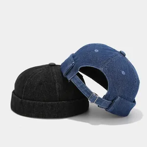 Retro washed denim docker hat in black and blue with adjustable metal buckle strap