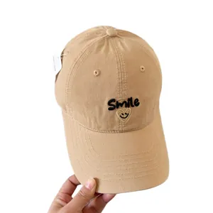 Khaki cotton baseball cap with Smile embroidery and heart face, hand-held view
