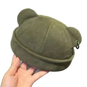 Dark green Docker hat with cute cat ears and metal ring detail in street style