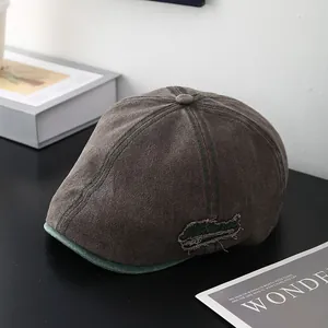 Détail de la casquette rétro en toile avec broderie de lettres et effet usé vintage