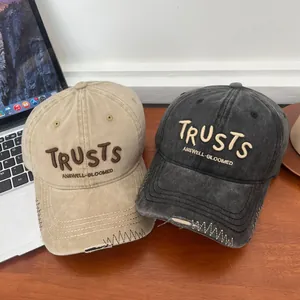 Vintage washed cotton baseball caps with TRUSTS embroidery and distressed brim detail