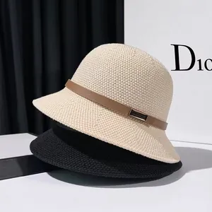 Elegant knit bucket hat with brown leather band and metal buckle in beige and black colors