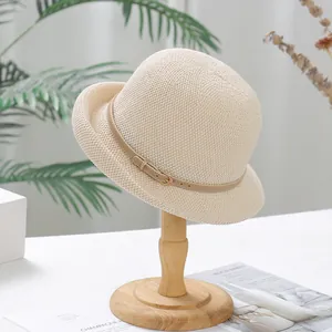 Elegant beige woven sun hat for women with thin brown leather strap and gold buckle detail