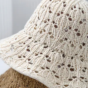 Close-up of cream crochet bucket hat showing intricate hollow patterns and textures