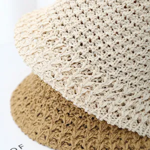 Close-up of the fine woven texture and breathable pattern on the beige straw bucket hat