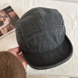 Detailed macro view of dark grey washed canvas 5-panel camp hat with reinforced stitching