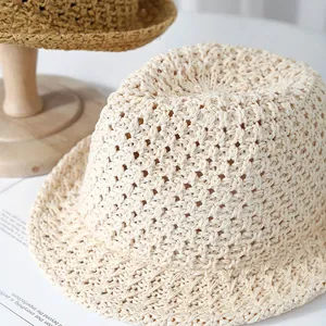 Detailed close-up of hollow crochet knit texture on this cream summer sun bucket hat