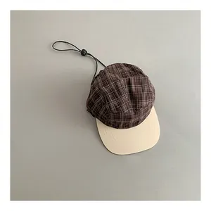 Top view of vintage plaid baseball cap featuring a contrast brim and black windproof cord