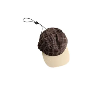 Vintage checkered five-panel baseball cap with beige flat brim and adjustable toggle