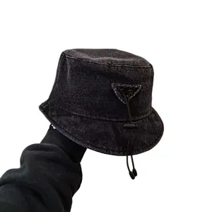 Asymmetrical charcoal denim bucket hat with adjustable drawstring and triangle patch