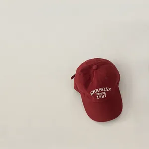 Retro deep red baseball cap with white AWESOME SINCE 1987 embroidery and wide brim
