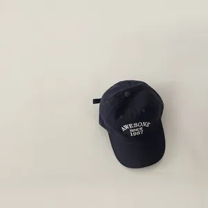 Detail of vintage navy baseball cap with Awesome Since 1987 embroidery and white text