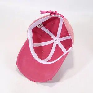 Detailed interior of rose pink distressed baseball cap showing white sweatband and drawstring