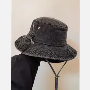 Retro washed denim bucket hat in charcoal grey with wide brim and adjustable chin strap