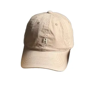 Minimalist beige cotton baseball cap with H embroidery and adjustable crown