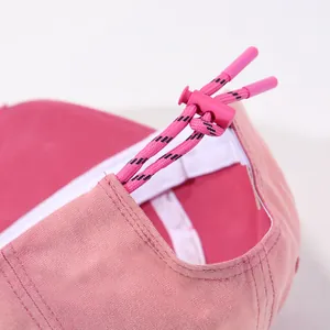 Detail of pink baseball cap back with two-tone woven adjustable rope and pink buckle