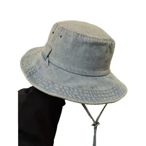 Vintage light blue washed denim bucket hat with adjustable windproof cord and metal eyelets