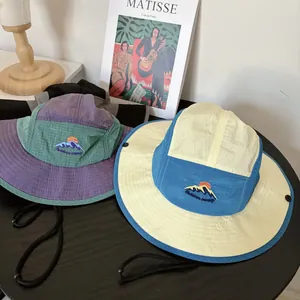 Close-up of Outdoor Camp embroidery on quick-dry mountain hats with adjustable chin strap