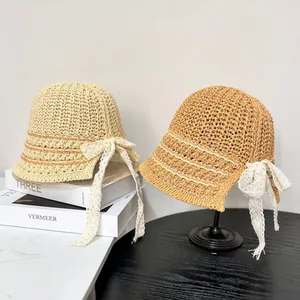 Summer woven bucket hat for women with elegant lace bow detail in beige and tan colors