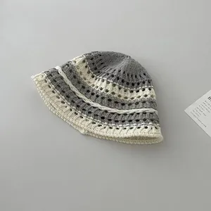 Detail view showing hollow knit texture and grey striped pattern of the bucket hat
