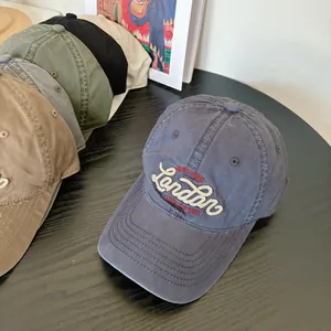 Navy washed cotton baseball cap with London embroidery and stacked multi-color options