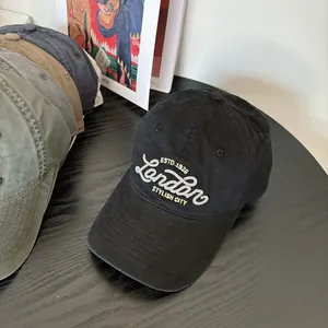 Detail of black cotton baseball cap with white London embroidery and ESTD 1926 lettering
