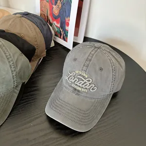 Detail of vintage washed cotton baseball cap with London embroidery and curved brim