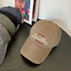 Detail showing high-quality letter embroidery on washed cotton baseball cap with curved brim