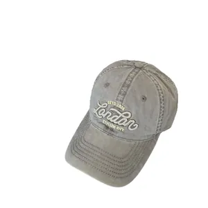 Distressed grey baseball cap with London embroidery and a wide brim for outdoor sun protection