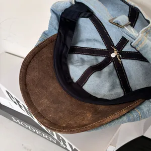 Detailed interior of denim baseball cap with 100% cotton label and metal buckle