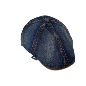 Vintage navy washed denim newsboy cap with orange stitching and brown leather trim detailing