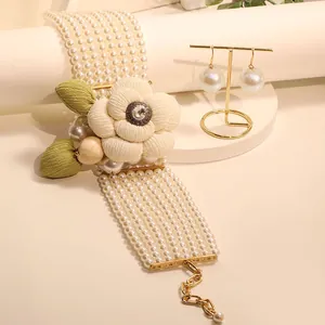 Elegant multi-layer pearl choker with a cream camellia flower and sparkling crystal core