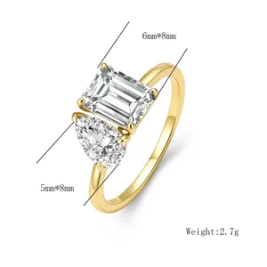 Macro shot of S925 silver ring featuring emerald-cut and pear-cut cubic zirconia stones