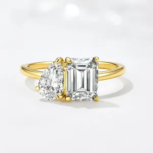 Toi et Moi gold ring featuring pear and emerald cut zircons in a minimalist luxury design