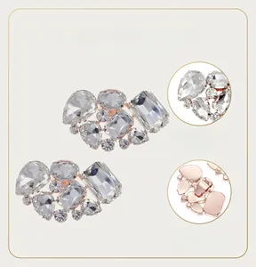 Detail view of crystal rhinestone shoe clips with copper base and claw setting for wedding shoes