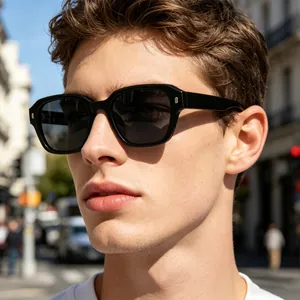 Close-up of black square polarized sunglasses with silver metal accents on a male model