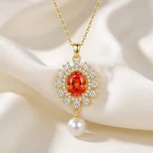 Elegant gold necklace with orange gemstone flower pendant and white pearl on silk