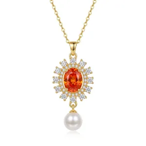 Elegant gold titanium necklace featuring an orange gemstone, diamond halo, and pearl drop