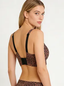 Detail of leopard print bra with adjustable straps and back hook closure on model