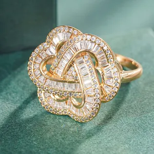 Macro detail of luxury gold floral cocktail ring with baguette and round cut crystals