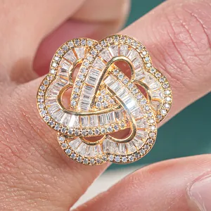 Macro shot of gold-plated three-heart flower ring with pavé-set cubic zirconia stones