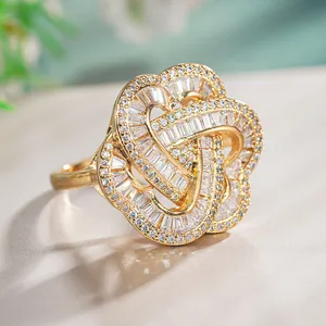 Luxurious gold-plated ring with intricate floral heart design and sparkling white zircons